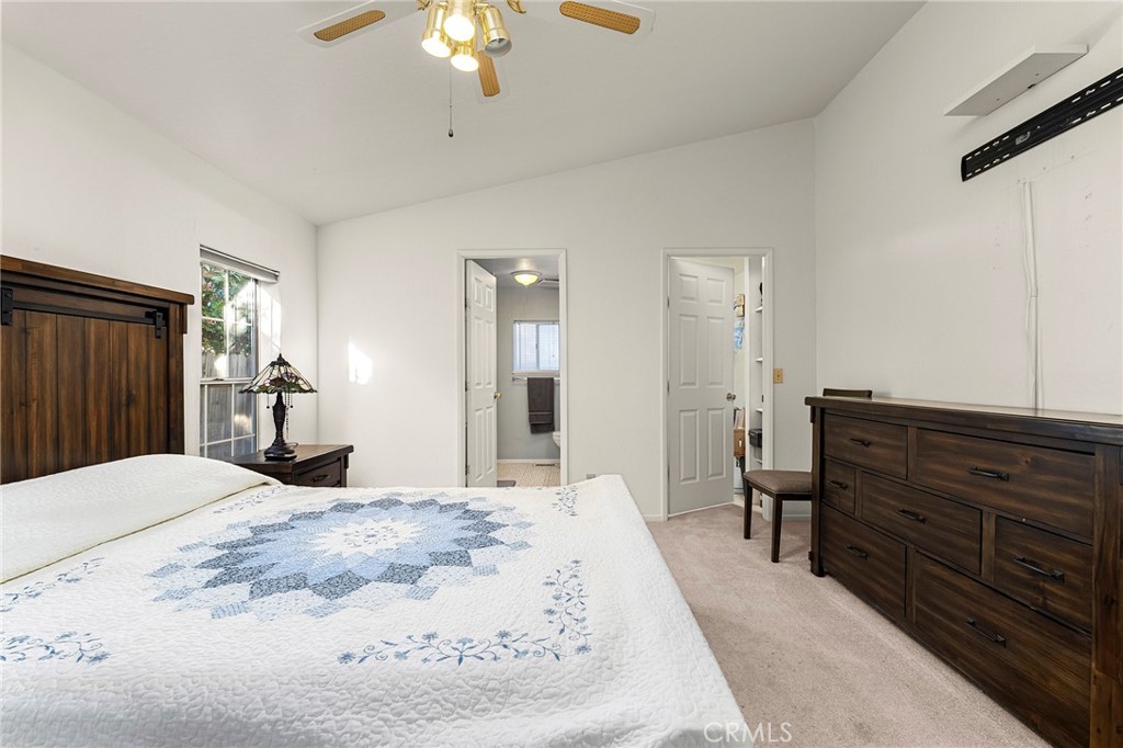 2050 Springfield Drive, Unit 323 Chico, CA 95928 - Photo 30 of 43 a bedroom with a bed and a chandelier