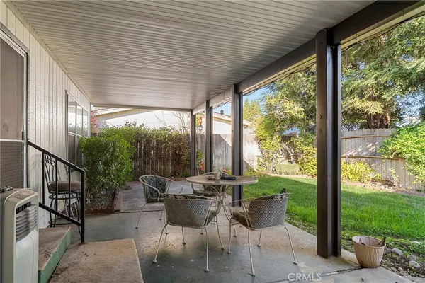 a patio with yard table and chairs