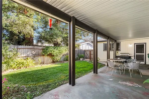 a view of a porch with chairs and backyard