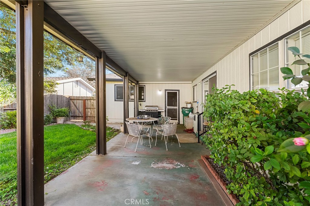 2050 Springfield Drive, Unit 323 Chico, CA 95928 - Photo 37 of 43 a view of a patio with table and chairs potted plants with floor to ceiling window