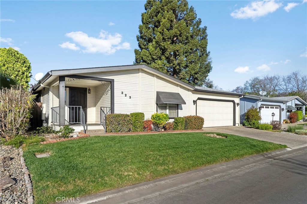 2050 Springfield Drive, Unit 323 Chico, CA 95928 - Photo 9 of 43 a front view of a house with a yard and garage
