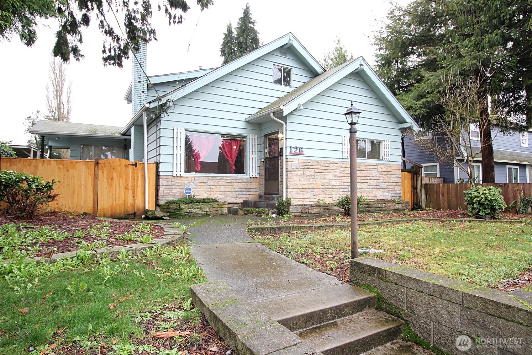 a view of a house with backyard and a tree