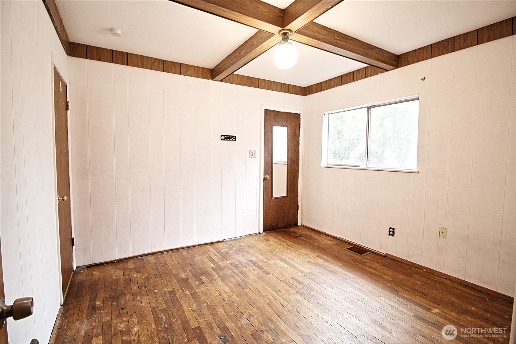 126 East 64th Street Tacoma, WA 98404 - Photo 11 of 36 an empty room with wooden floor and windows
