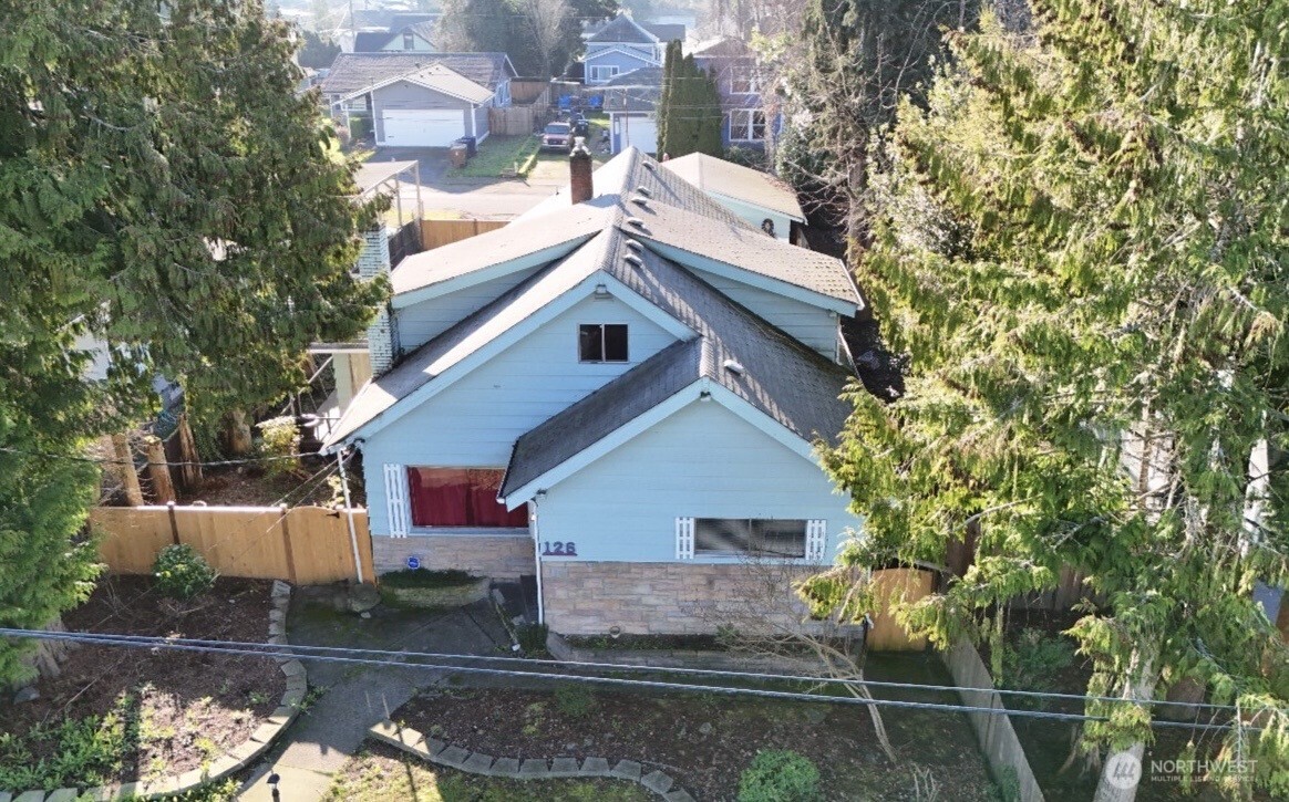 126 East 64th Street Tacoma, WA 98404 - Photo 2 of 36 a front view of a house with a yard