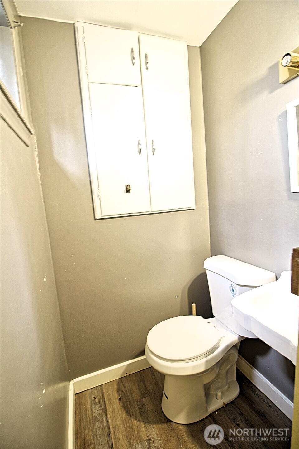 126 East 64th Street Tacoma, WA 98404 - Photo 24 of 36 a white toilet sitting next to a small sink