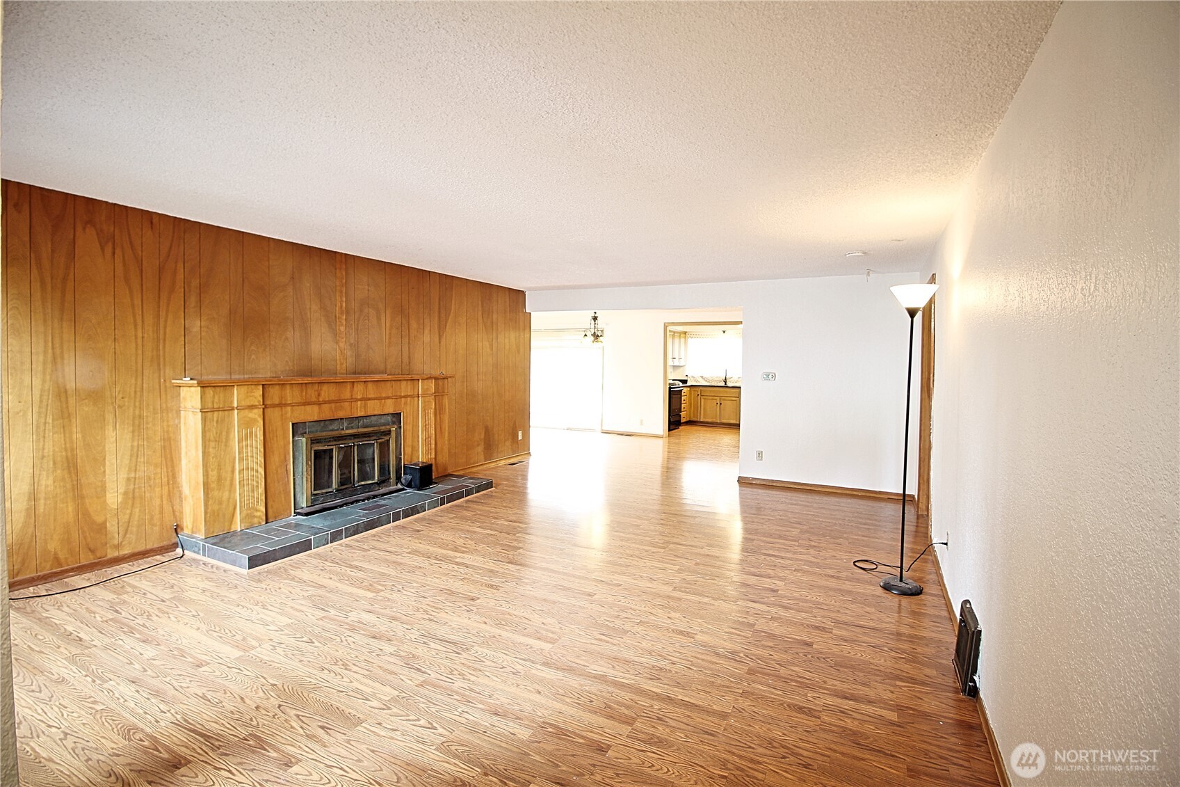 126 East 64th Street Tacoma, WA 98404 - Photo 5 of 36 a view of a livingroom with wooden floor and a fireplace