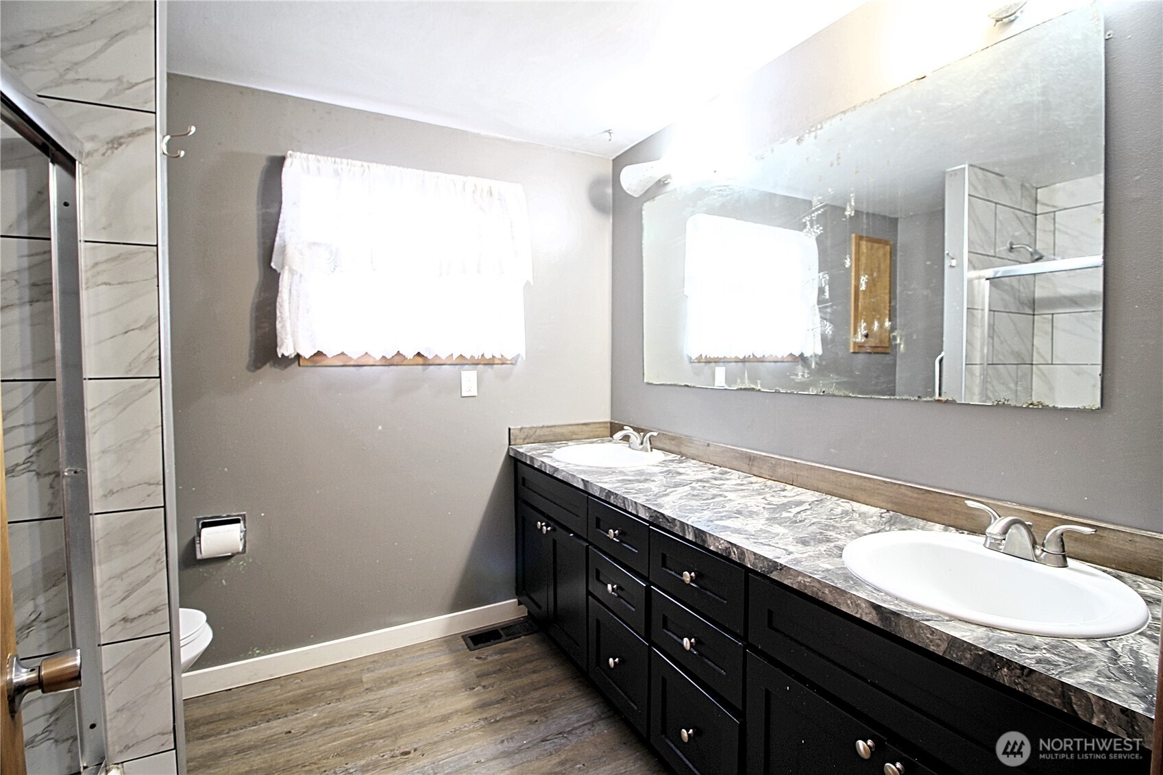 126 East 64th Street Tacoma, WA 98404 - Photo 7 of 36 a bathroom with a granite countertop sink mirror and a window