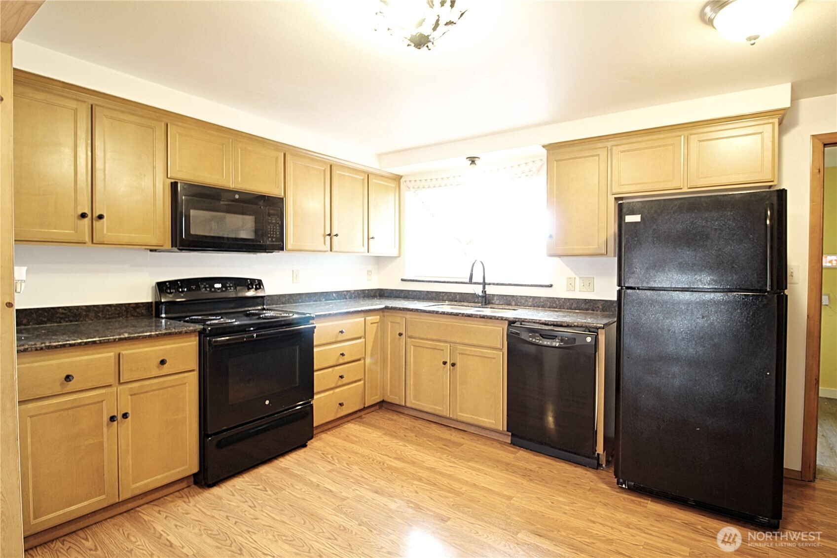 126 East 64th Street Tacoma, WA 98404 - Photo 9 of 36 a kitchen with a refrigerator sink and stove