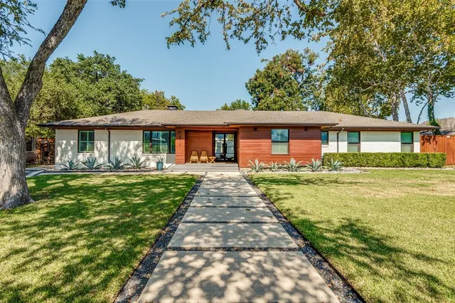 a front view of a house with a garden