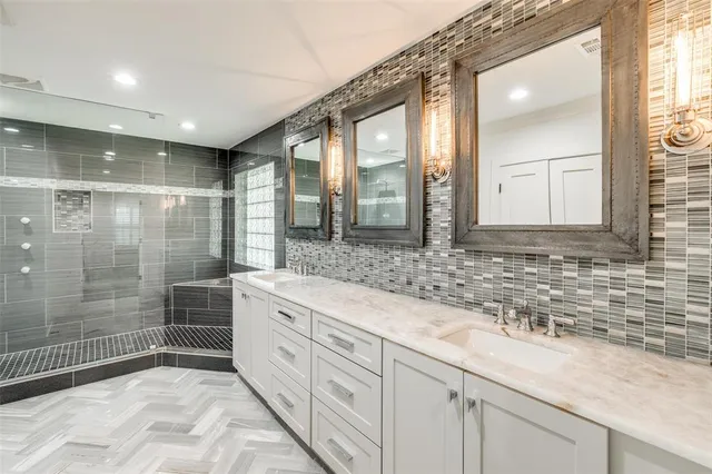 a bathroom with a granite countertop sink mirror and double