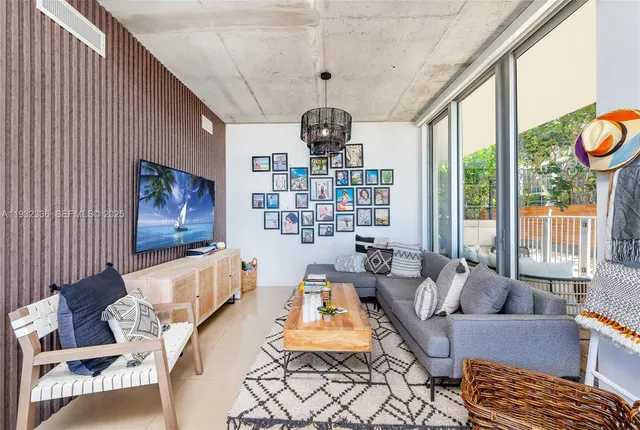 a living room with furniture and a chandelier
