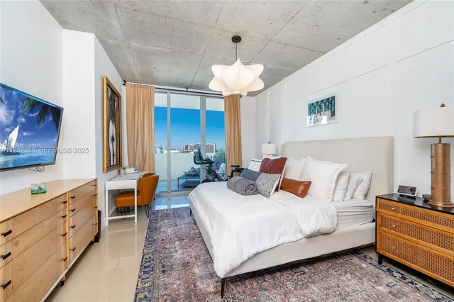 a bed room with bed and a chandelier