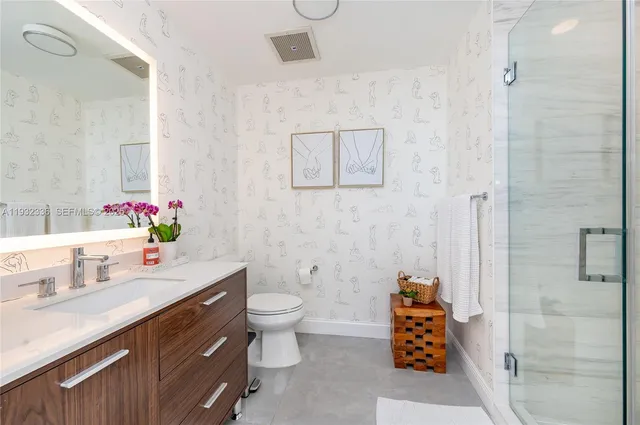 a bathroom with a sink toilet and shower