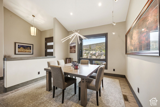 1130 Pace Road Park City, UT 84098 - Photo 27 of 73 Modern dining area with a large picture window, a contemporary linear chandelier, and recessed lighting