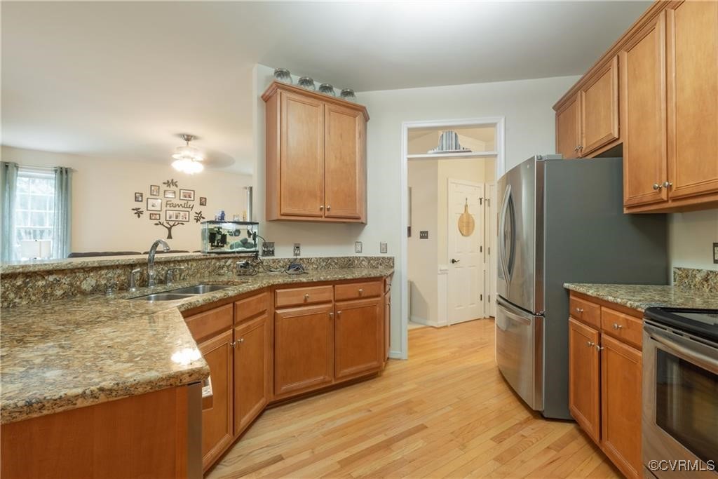 862 Club Ridge Court Chester, VA 23836 - Photo 19 of 50 Kitchen featuring sink, light stone countertops, a