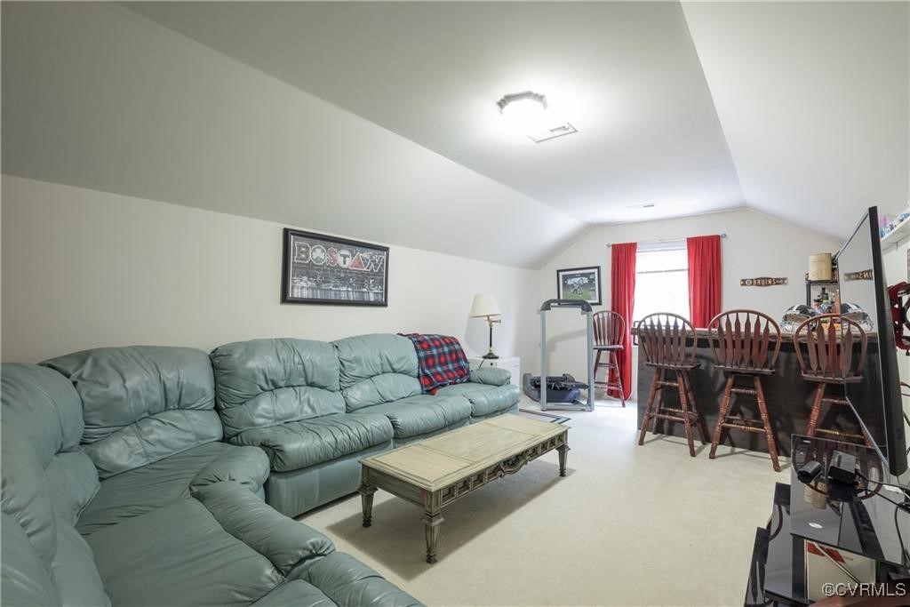862 Club Ridge Court Chester, VA 23836 - Photo 36 of 50 Living room featuring light carpet and lofted ceil