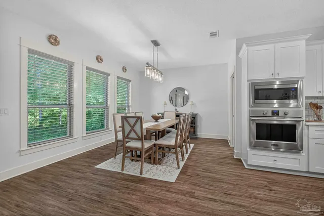 a view of a dining room with furniture and a window