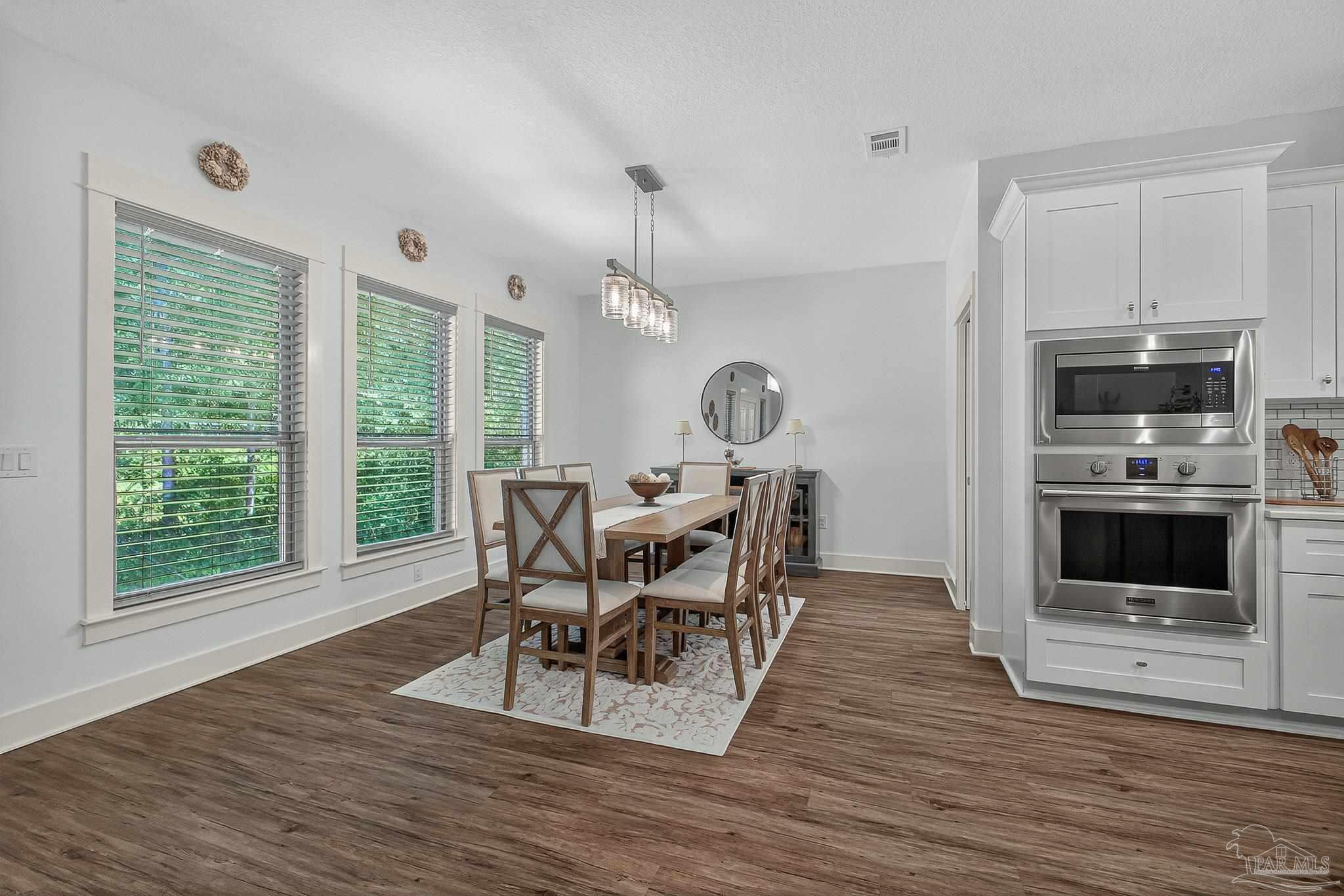 2480 Carthage Court Cantonment, FL 32533 - Photo 12 of 59 a view of a dining room with furniture and a window