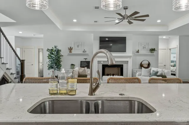 a kitchen with a sink a counter top space and a fireplace