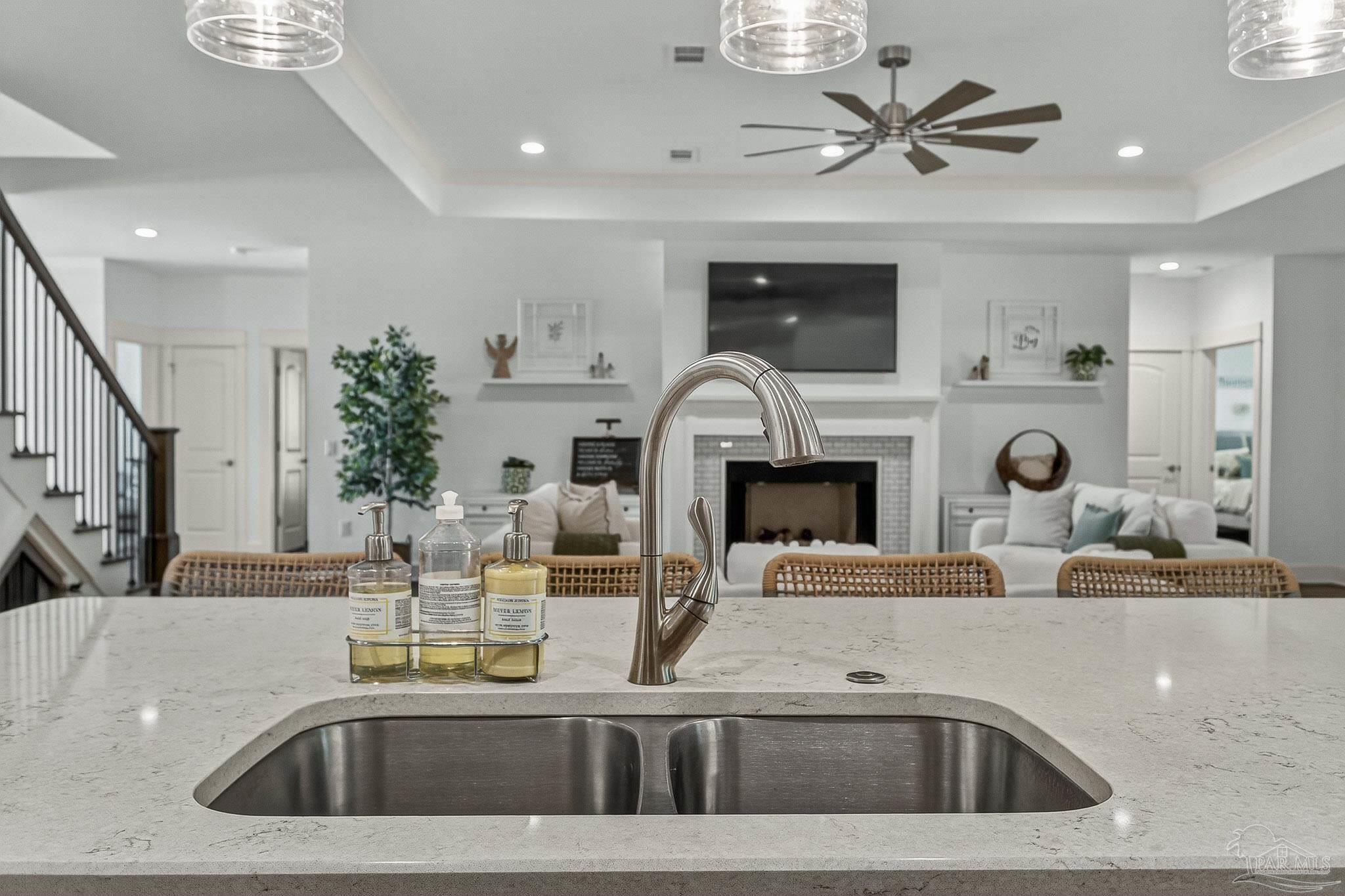 2480 Carthage Court Cantonment, FL 32533 - Photo 17 of 59 a kitchen with a sink a counter top space and a fireplace