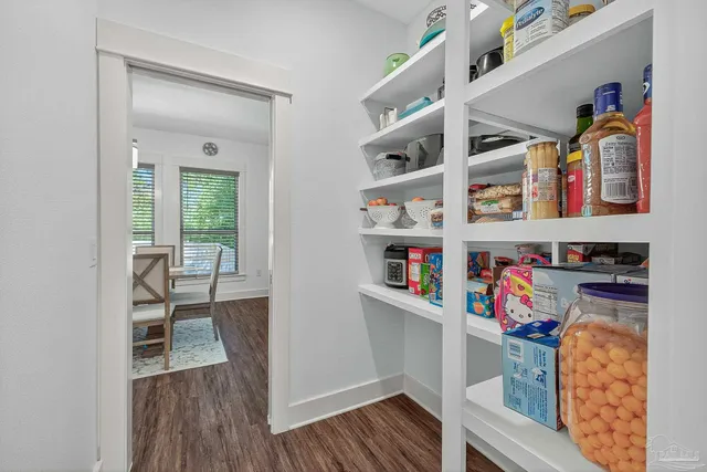 a dining room with furniture and wooden floor