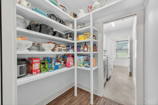 a bedroom with a large bed and a large window