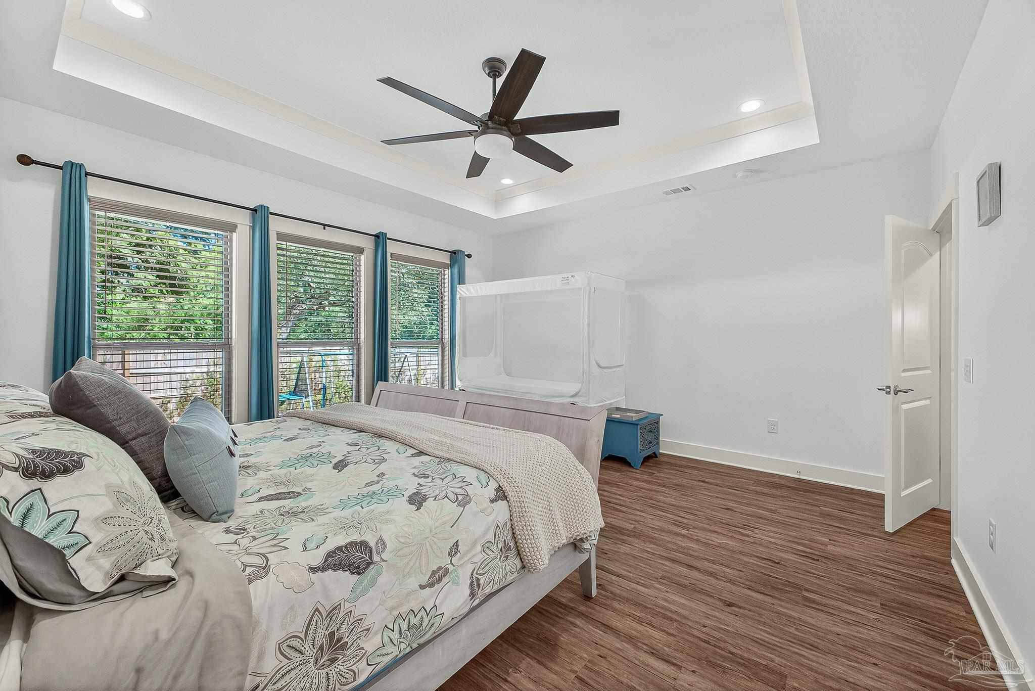 2480 Carthage Court Cantonment, FL 32533 - Photo 32 of 59 a bedroom with a large bed and a large window