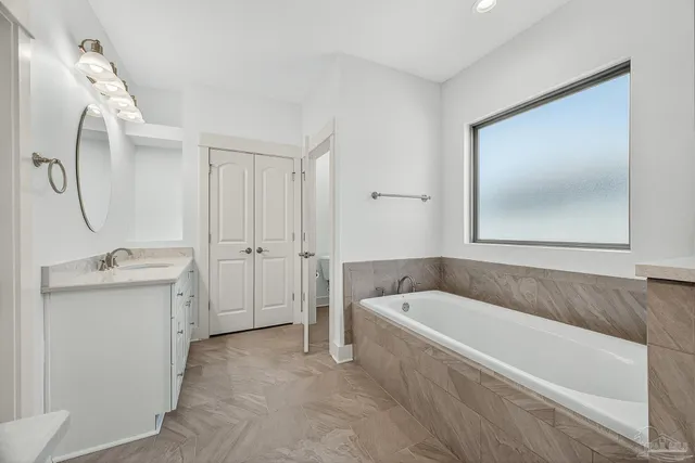 a living room with furniture and a view of kitchen