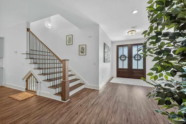 a view of entryway with stairs and wooden floor