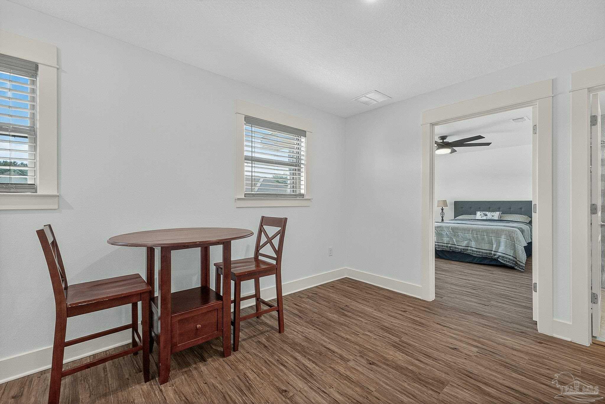 2480 Carthage Court Cantonment, FL 32533 - Photo 44 of 59 a view of a livingroom with furniture and wooden floor