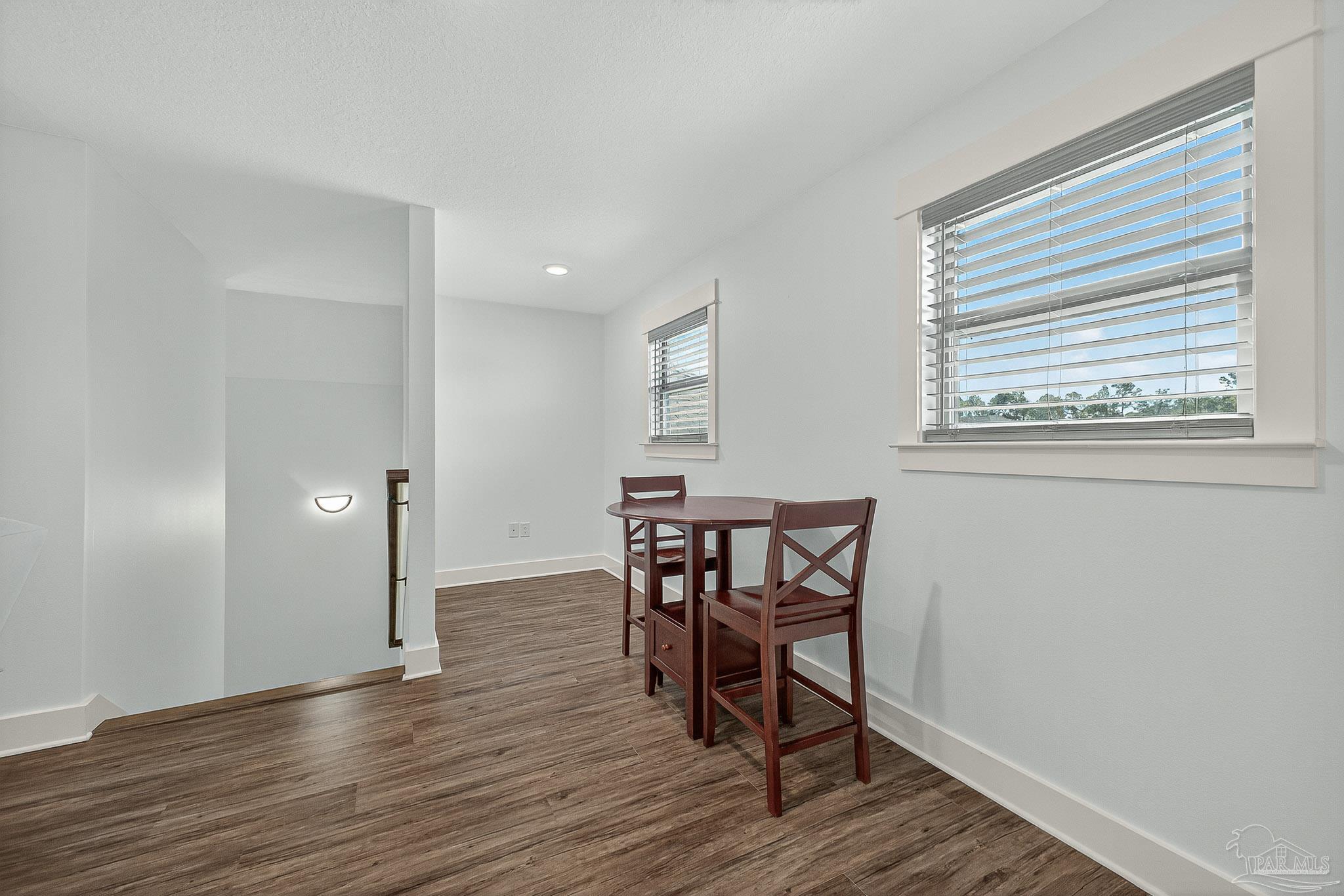 2480 Carthage Court Cantonment, FL 32533 - Photo 45 of 59 a view of a dining room with furniture and wooden floor