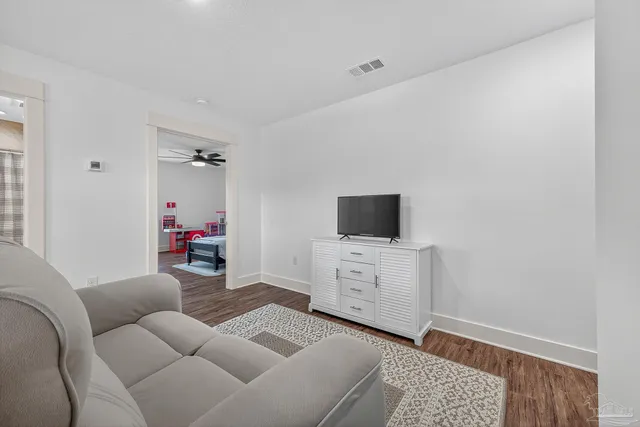 a bedroom with furniture and large windows