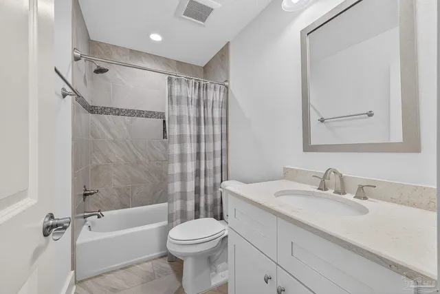 a front view of a house with a garden and yard