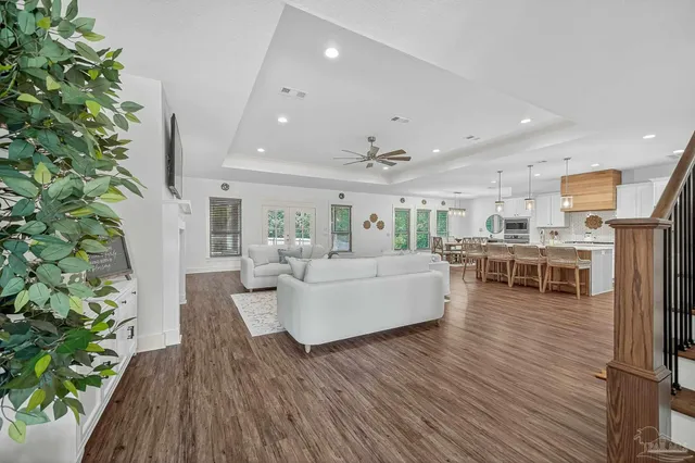 a living room with furniture and a potted plant