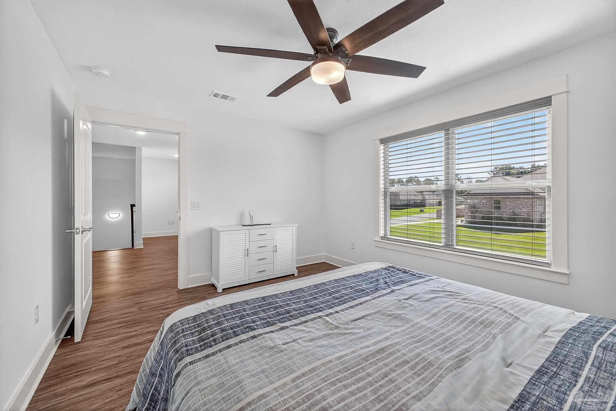 2480 Carthage Court Cantonment, FL 32533 - Photo 53 of 59 a bedroom with a bed and a window