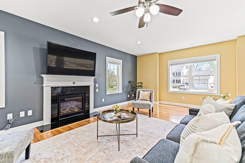 96 Clement Road Dracut, MA 01826 - Photo 16 of 41 a living room with furniture a flat screen tv and a fireplace