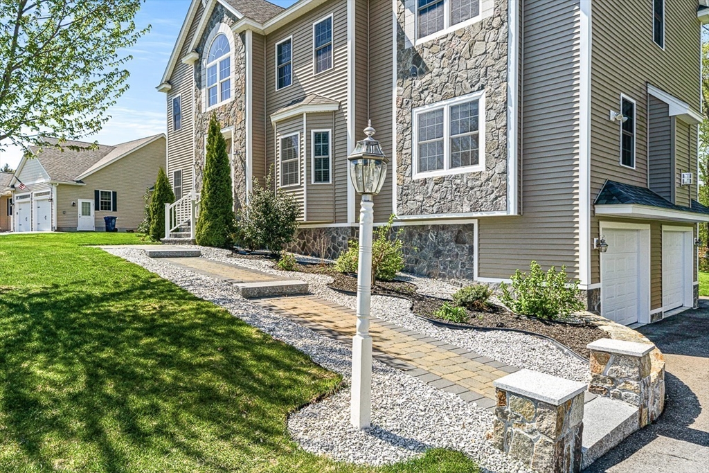 96 Clement Road Dracut, MA 01826 - Photo 2 of 41 a front view of a house with a yard
