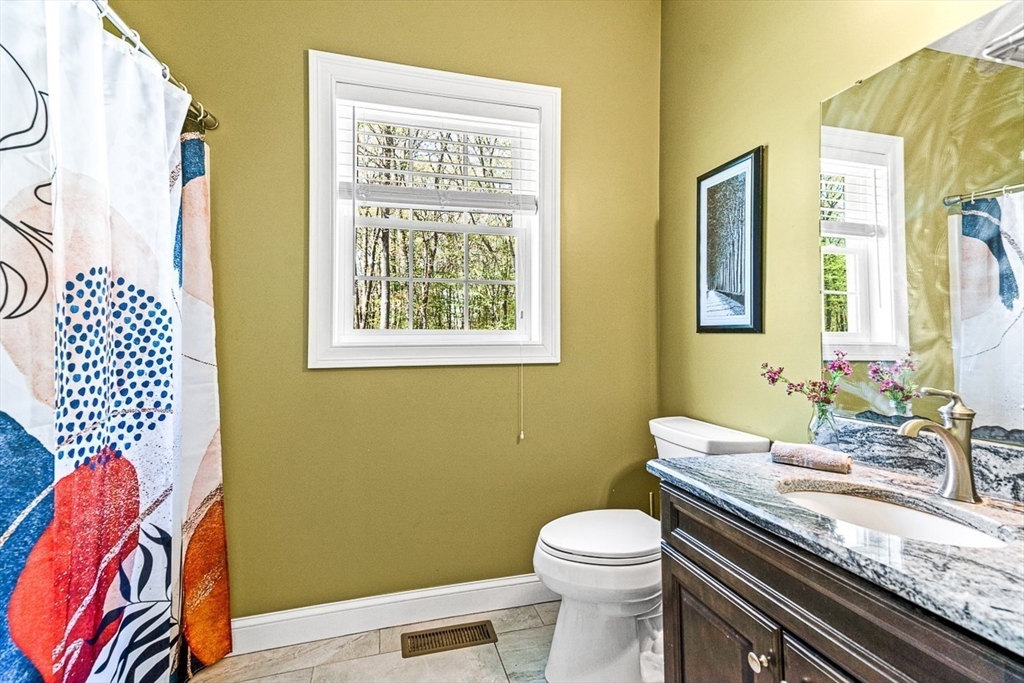 96 Clement Road Dracut, MA 01826 - Photo 21 of 41 a bathroom with a granite countertop toilet sink and mirror