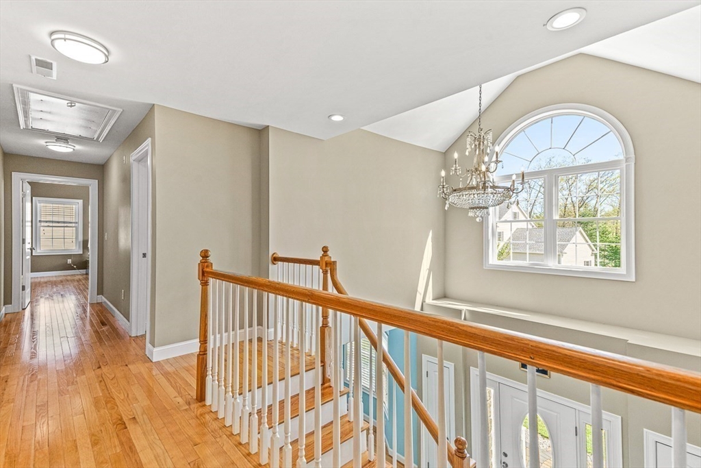 96 Clement Road Dracut, MA 01826 - Photo 22 of 41 a view of staircase with railing and a chandelier
