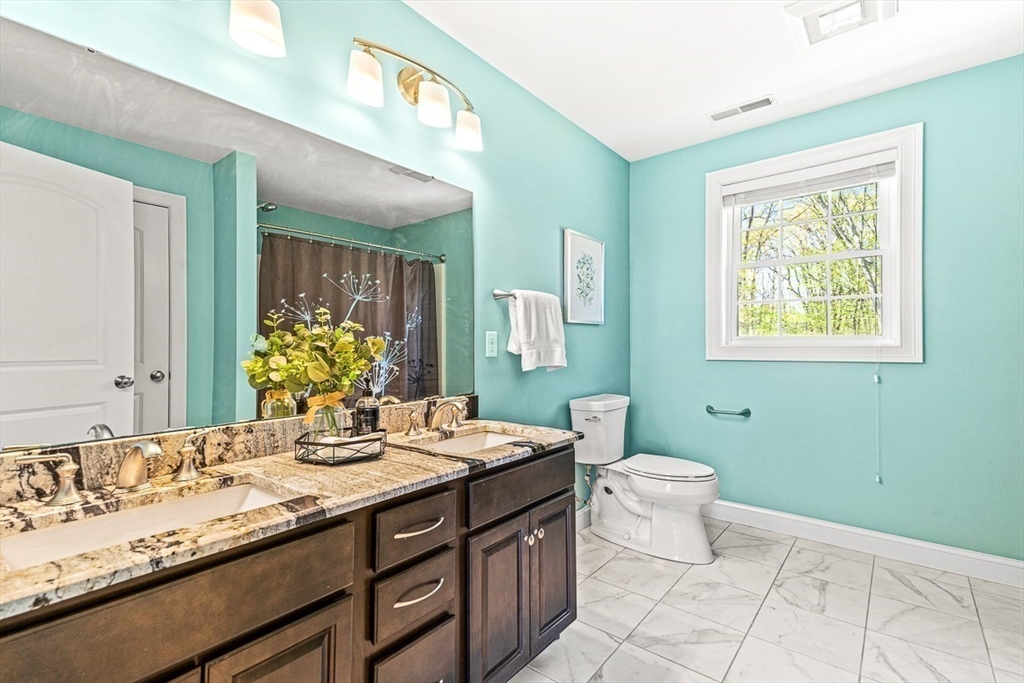 96 Clement Road Dracut, MA 01826 - Photo 27 of 41 a bathroom with a double vanity sink and a mirror