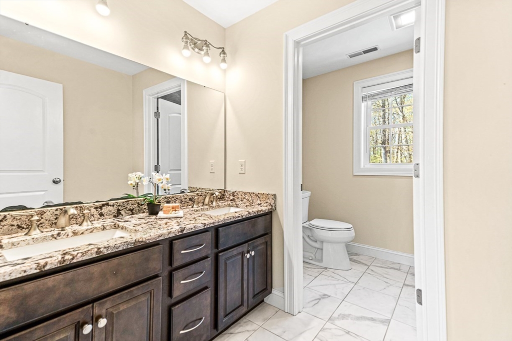 96 Clement Road Dracut, MA 01826 - Photo 28 of 41 a bathroom with a granite countertop toilet sink and mirror