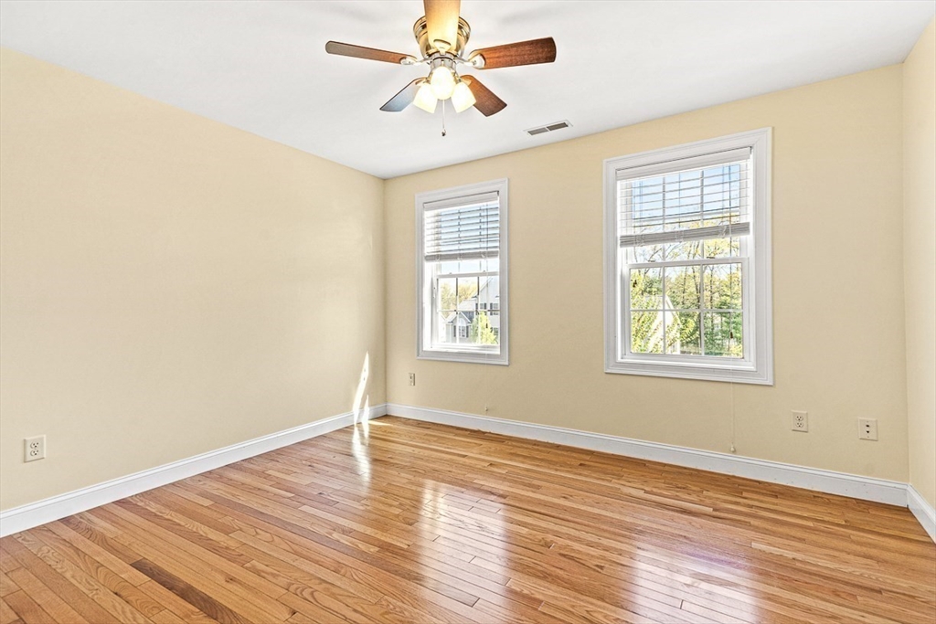 96 Clement Road Dracut, MA 01826 - Photo 29 of 41 a view of an empty room with wooden floor and a window