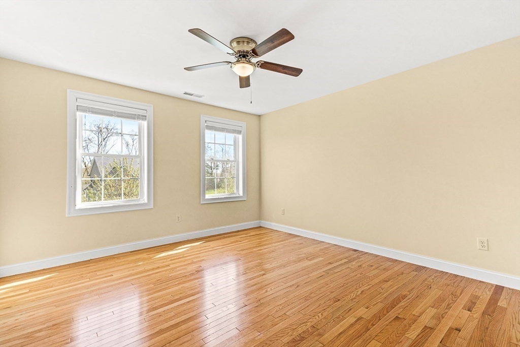 96 Clement Road Dracut, MA 01826 - Photo 30 of 41 a view of an empty room with wooden floor and a window