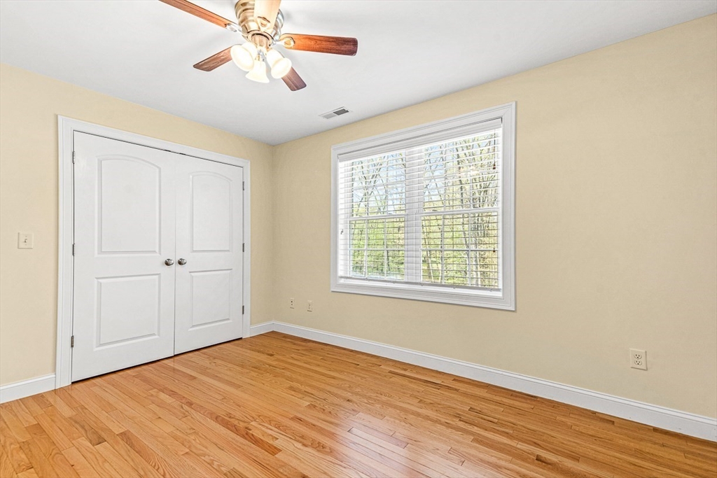 96 Clement Road Dracut, MA 01826 - Photo 32 of 41 a view of an empty room with a window and wooden floor
