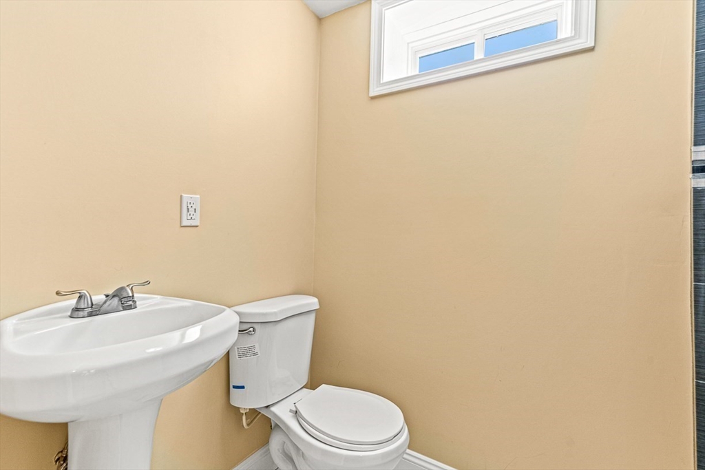 96 Clement Road Dracut, MA 01826 - Photo 33 of 41 a bathroom with a sink a toilet and a mirror
