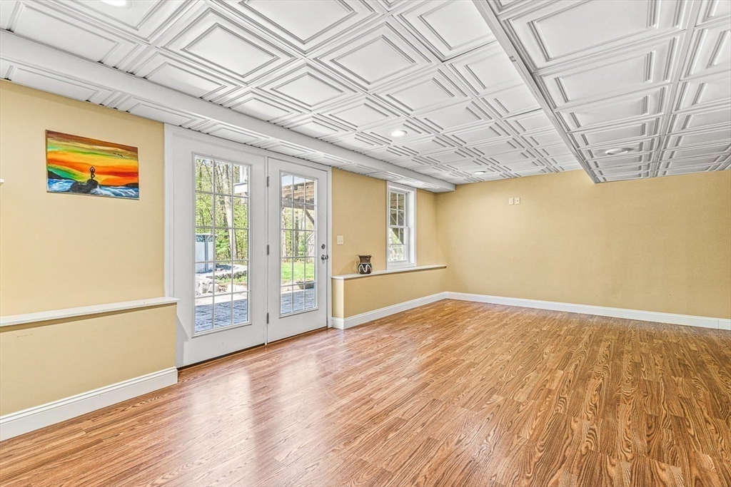 96 Clement Road Dracut, MA 01826 - Photo 35 of 41 a view of an empty room with wooden floor and a window