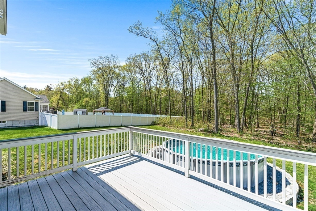 96 Clement Road Dracut, MA 01826 - Photo 37 of 41 a view of a wooden deck with a yard