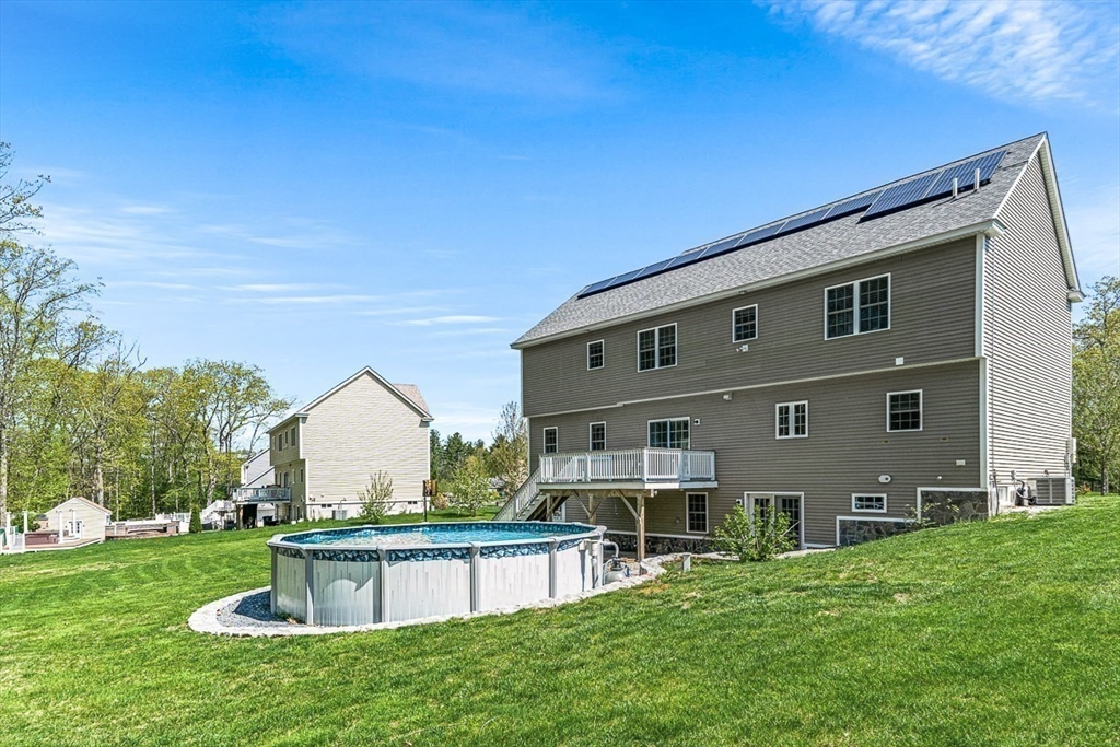 96 Clement Road Dracut, MA 01826 - Photo 39 of 41 a view of a house with a yard and sitting area