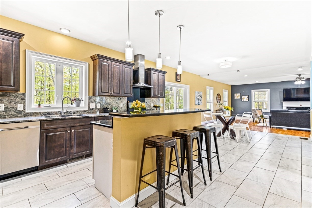96 Clement Road Dracut, MA 01826 - Photo 5 of 41 a kitchen with stainless steel appliances granite countertop table chairs and a view of living room