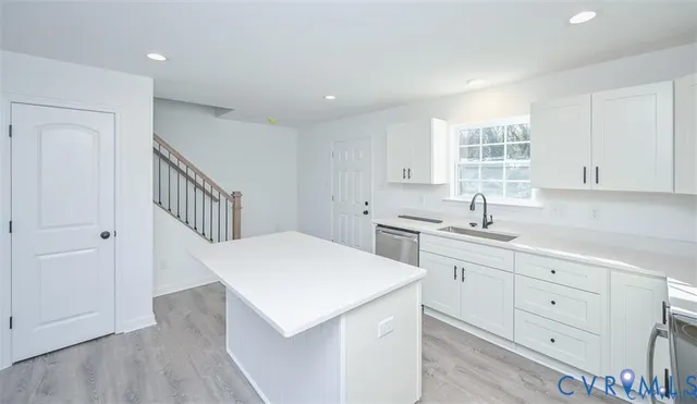 a kitchen that has a sink and a stove in it